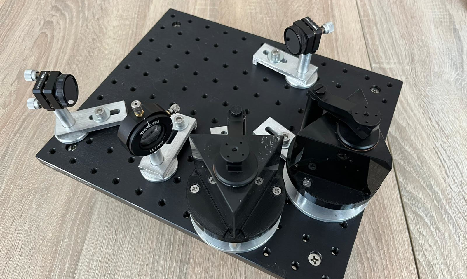 FLORES double-prism disperser and fold optics on the test breadboard
